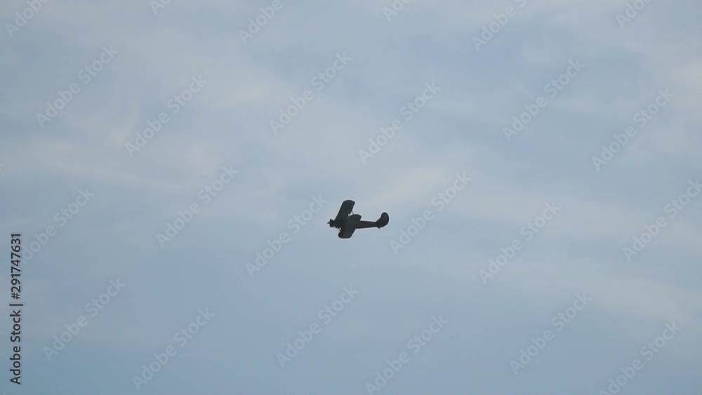A small plane aircraft biplane flying in the blue sky. Slow motion A small plane aircraft biplane flying in the blue sky. Slow motion