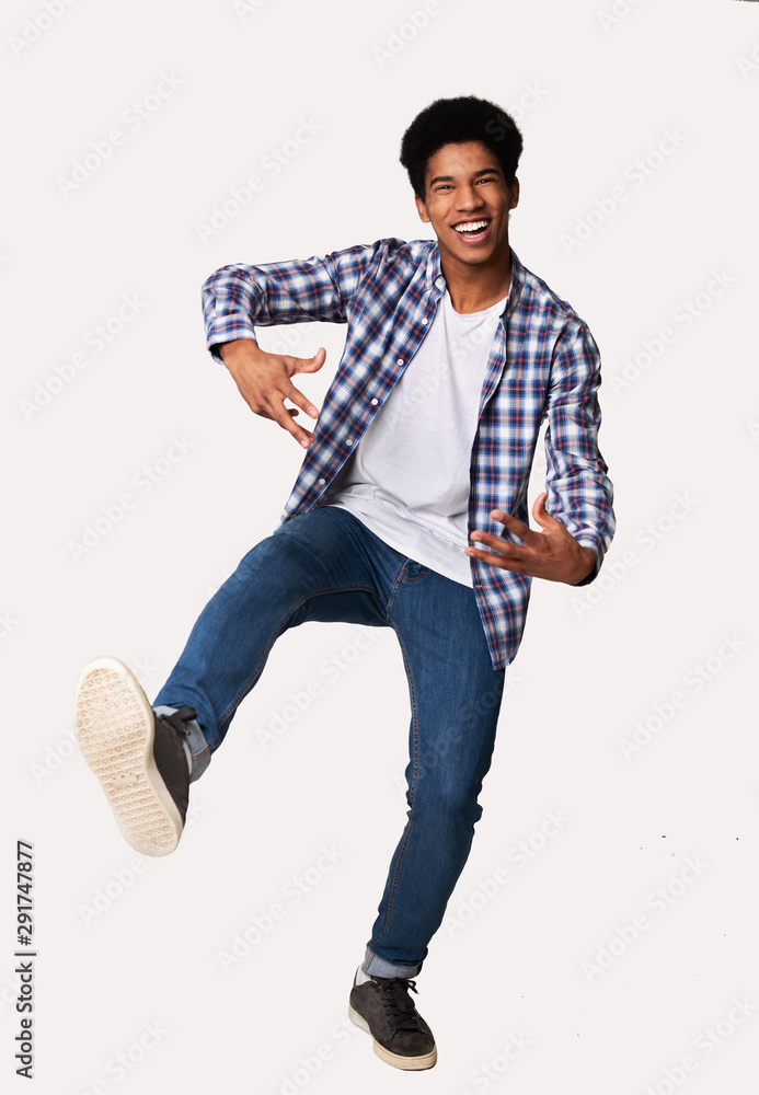 Naklejka premium Happy african-american guy having fun over white background