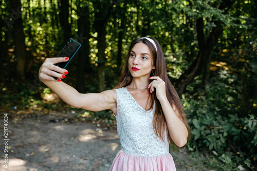 Beautiful girl doing a self-portrait on the phone photo