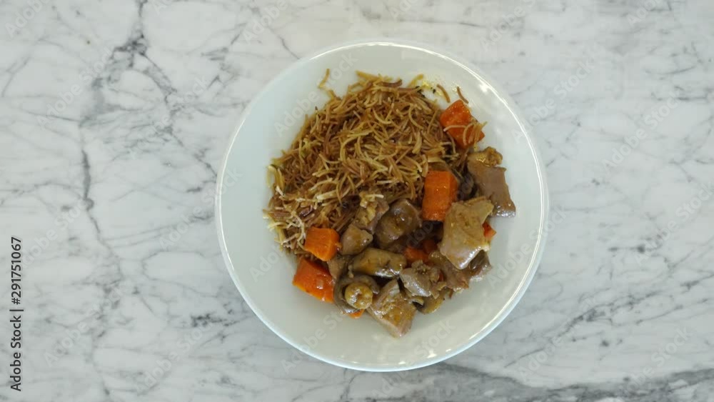 Top view, Spaghetti with vegetables and mushrooms on a plate. The plate rotates. Delicious, but unhealthy food concept. Top view, Spaghetti with vegetables and mushrooms on a plate. The plate rotates. Delicious, but unhealthy food concept.