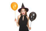 Beautiful woman in halloween costume holding balloons on white background