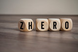 Cubes and dice with words from zero to hero on wooden background