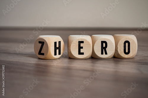 Cubes and dice with words from zero to hero on wooden background photo