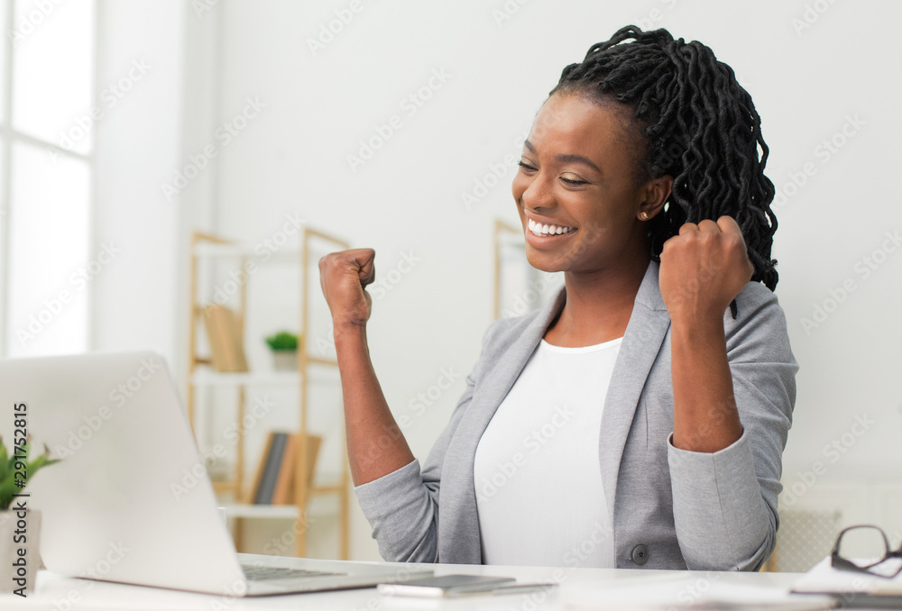 Black Lady Celebrating Business Success Sitting At Laptop In Office - obrazy, fototapety, plakaty 