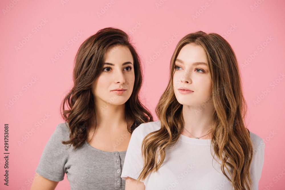 attractive women in t-shirts looking away isolated on pink attractive women in t-shirts looking away isolated on pink