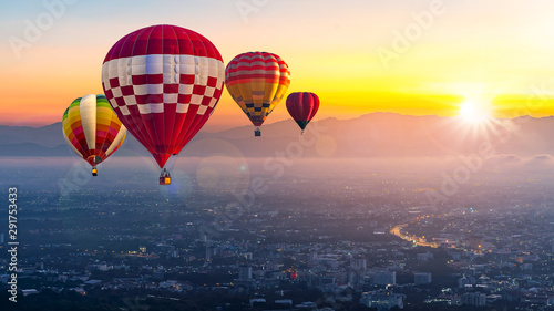 Chiang Mai, Doi Suthep in Thailand at sunrise -Landscape with hot air balloons flying over Chiang Mai City in sunlight and mist in the morning.