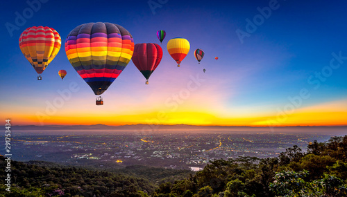 Hot air balloons flying over Doi Suthep National Park at sunrise in Chiang Mai Province, Thailand.