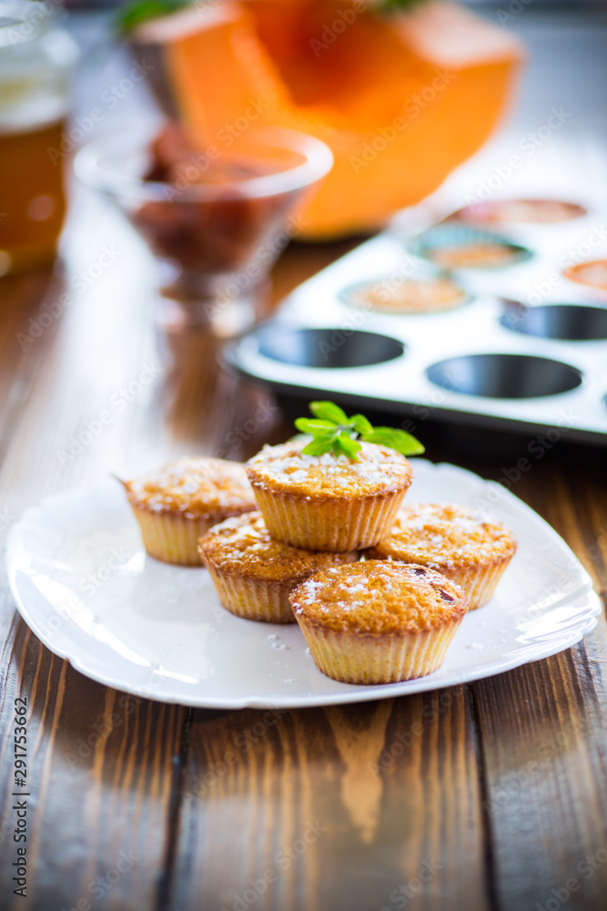 baked sweet pumpkin muffins with dried apricots inside, baked sweet pumpkin muffins with dried apricots inside,