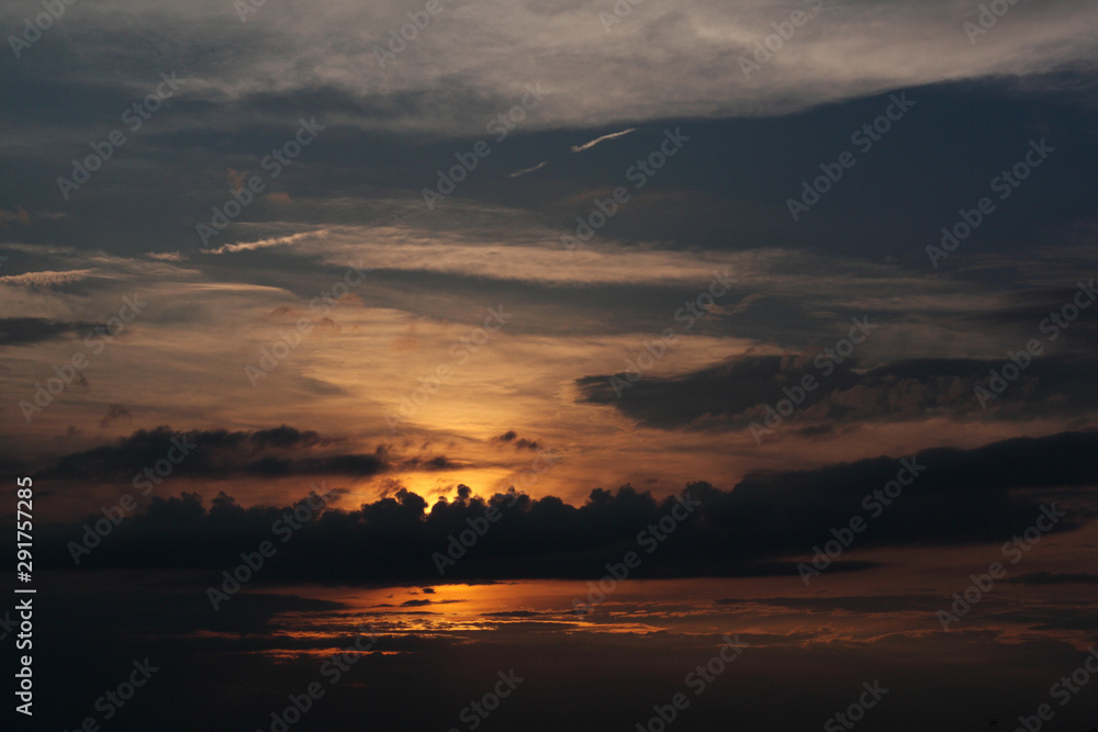 sunset - view of cloudy sky and setting sun