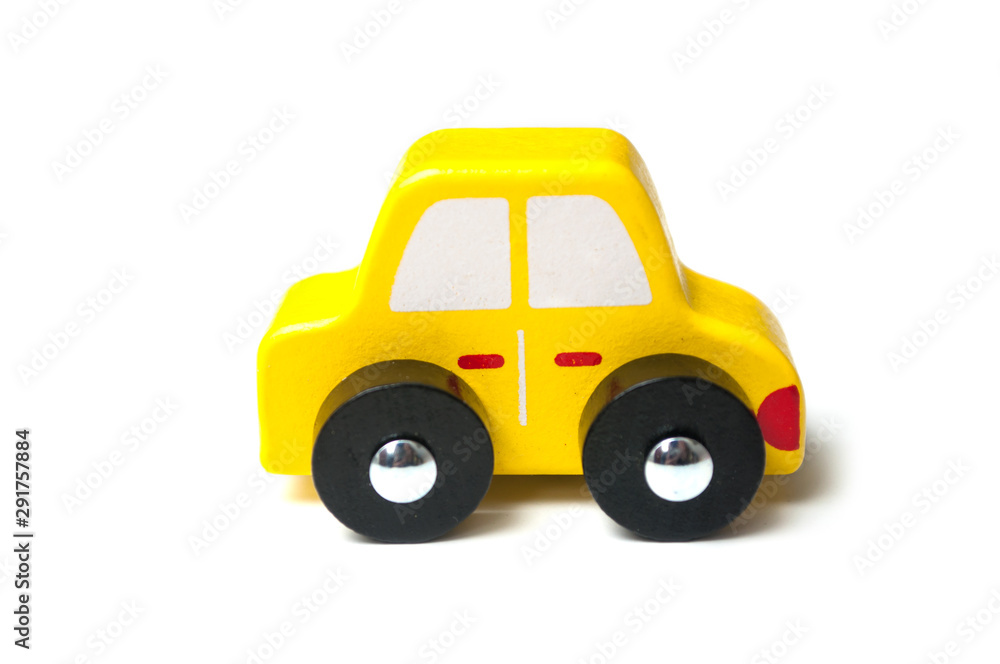 closeup of yellow miniature wooden car on white background