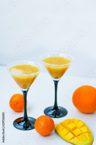 two tropical fruit cocktails on the table