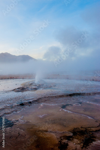 El Tatio, Atacama, Chile. Active geysers comes out of the ground. Hot vapor erupting activity, thick flume of steam. Tourists watching geyser in the Los Géiseres del Tatio area in the Atacama Desert