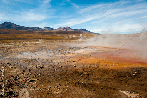 El Tatio, Atacama, Chile. Active geysers comes out of the ground. Hot vapor erupting activity, thick flume of steam. Tourists watching geyser in the Los Géiseres del Tatio area in the Atacama Desert