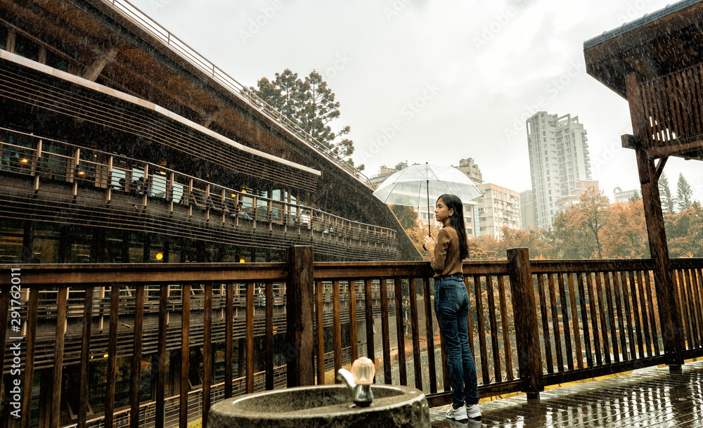 A woman in the rain at Taipei Public Library Beitou Branch