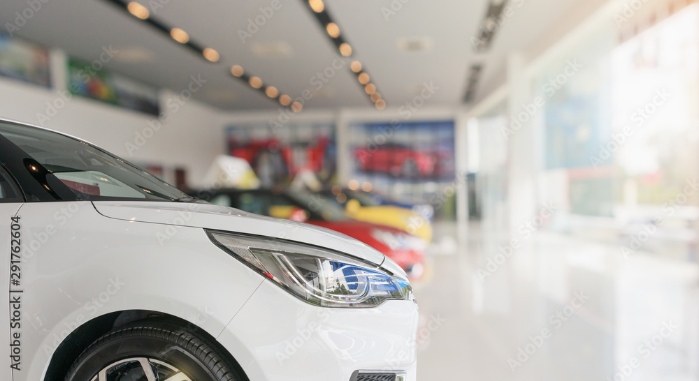 closeup front of new car in showroom background