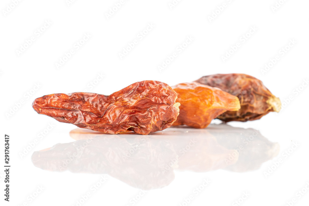 Group of three whole dry red chili pepper peperoncino isolated on white background