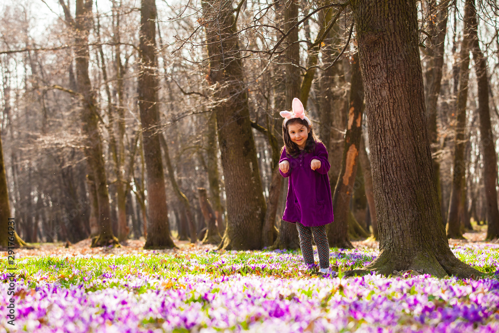 Fototapeta premium Little girl with banny ears in spring park