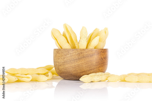 Lot of whole uncooked pasta cavatelli in wooden bowl isolated on white background photo