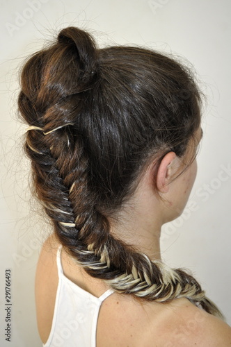 Hairstyle on long hair. Braid fishtail