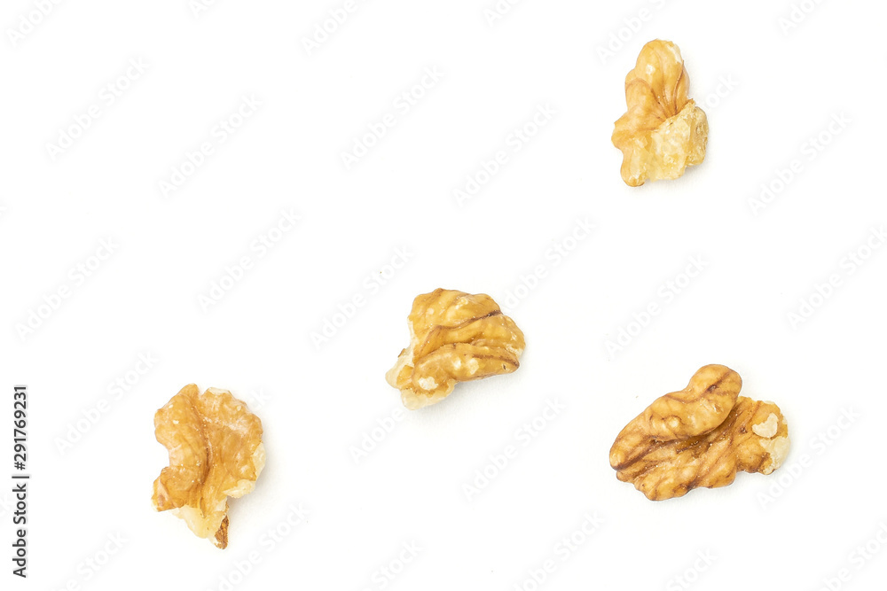 Group of four halves of brown almond nut flatlay on white background