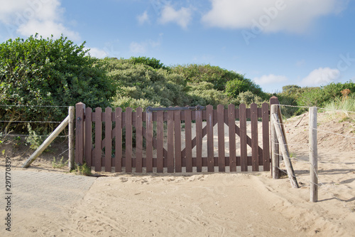 A gate blocks access to the dunes.