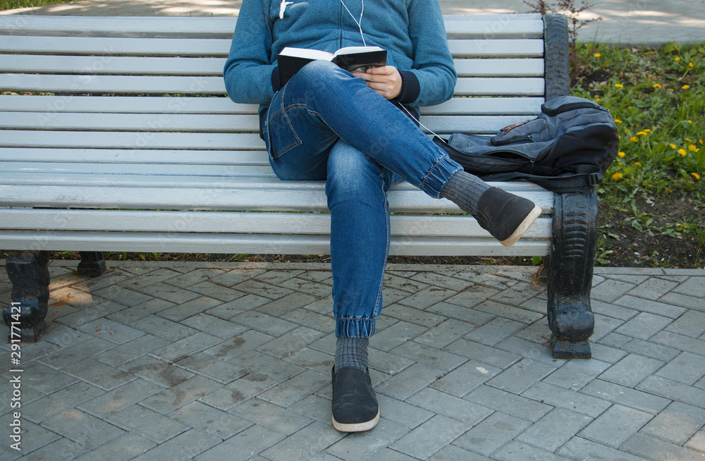 guy sitting on a bench legs crossed guy sitting on a bench legs crossed