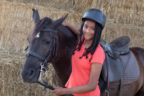 Beautiful teenager with his horse learning to ride