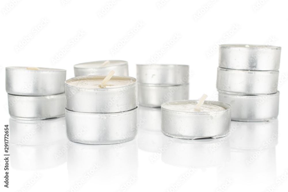 Lot of whole light waxy white tea candle stack isolated on white background Lot of whole light waxy white tea candle stack isolated on white background