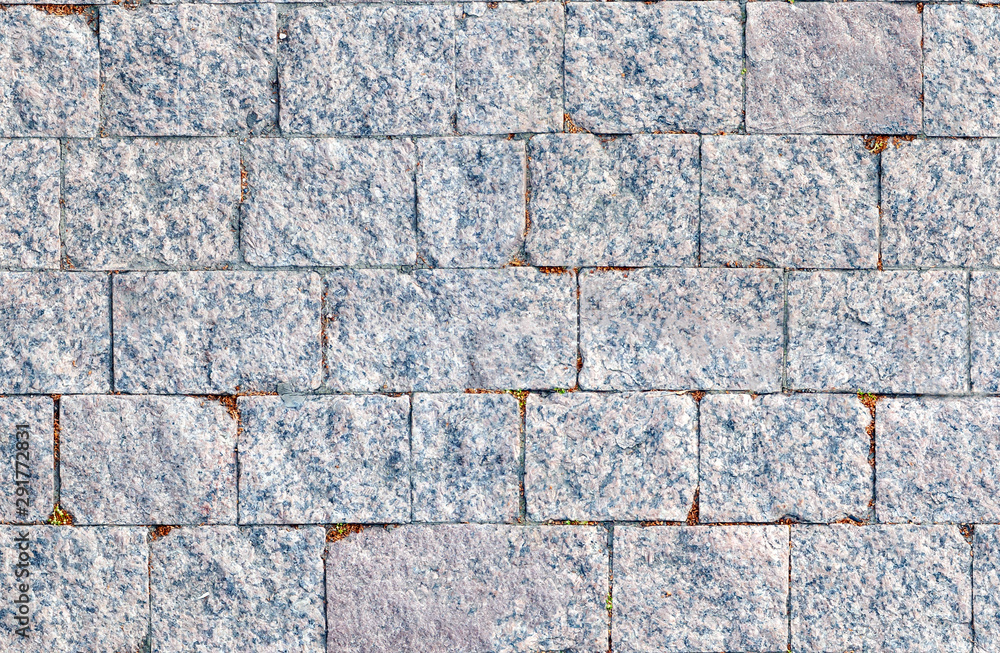 Fototapeta premium The texture of pavers made of gray stone. Stone background.