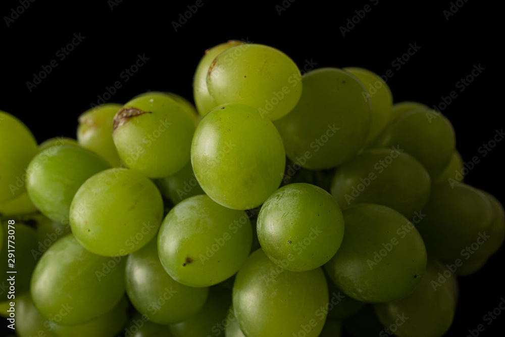 Lot of whole fresh green grape closeup isolated on black glass Lot of whole fresh green grape closeup isolated on black glass