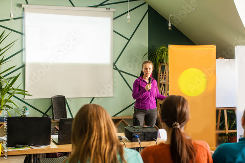 Speaker on informal meeting with students, lecture with projector photo