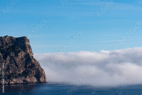 Rock with Budda silhouette on sea