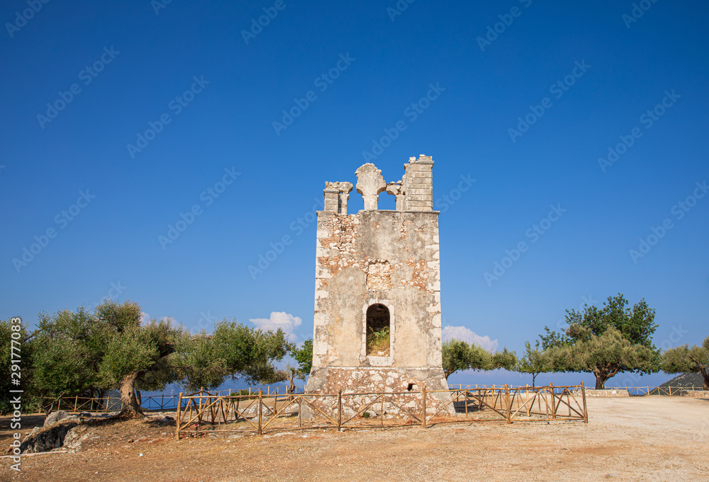 Summer sunny day the old bell tower of the Monastery of Argilion in the open territory for tourist visits - Sami, Kefalonia island, Greece.