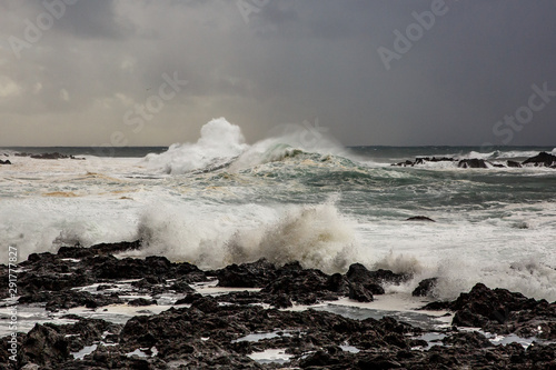 Big waves crashing near a rocky shore