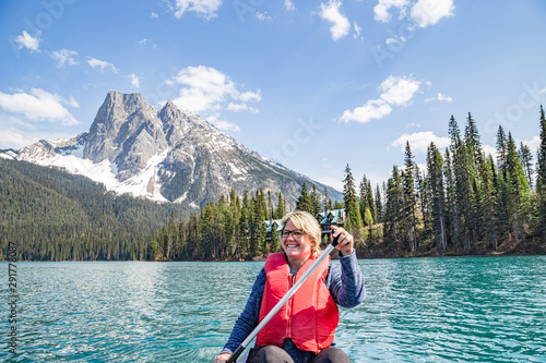 Woman paddling kayak on Emerald Lake, Yoho National Park