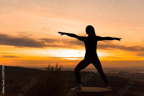 Silhouette woman coach yoga practice at sunset. Yoga concept.