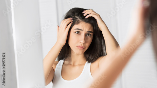 Girl Looking At Hair Flakes In Mirror Standing In Bathroom, Panorama photo