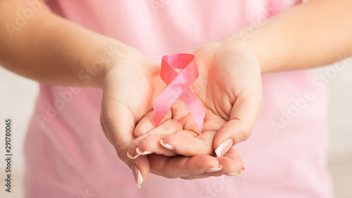 Unrecognizable Woman Showing Pink Breast Cancer Ribbon, White Background, Panorama