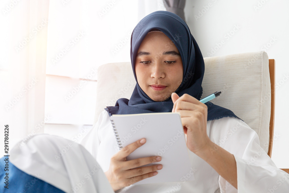 Young Muslim women Students is a creative freelance journalist sit writing to be entrepreneur job concept for hijab girl Islam religion Asian ethnic joyful internet banking on tablet mobile smartphone Young Muslim women Students is a creative freelance journalist sit writing to be entrepreneur job concept for hijab girl Islam religion Asian ethnic joyful internet banking on tablet mobile smartphone