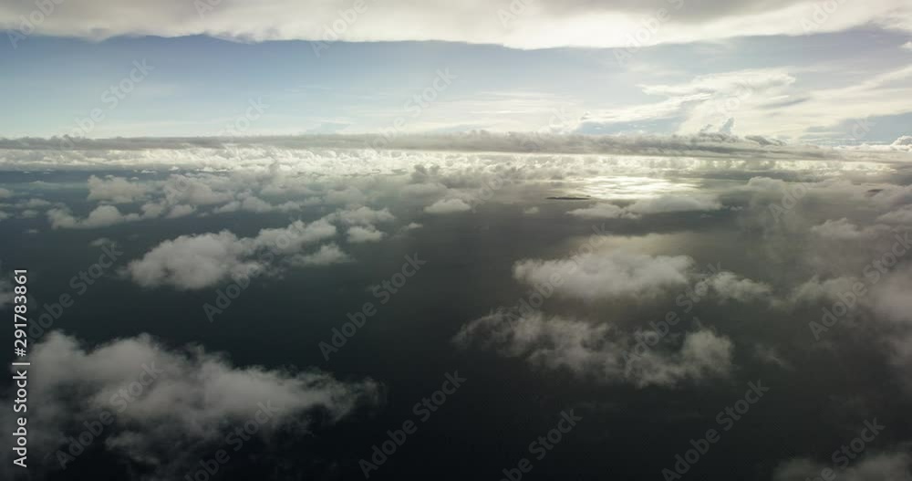 Wide aerial, view of ocean clouds from airplane Wide aerial, view of ocean clouds from airplane