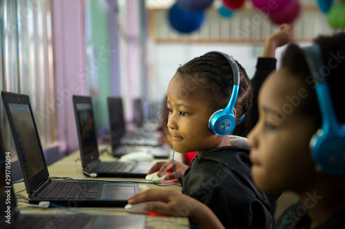School girl child sitting and concentrating at a laptop