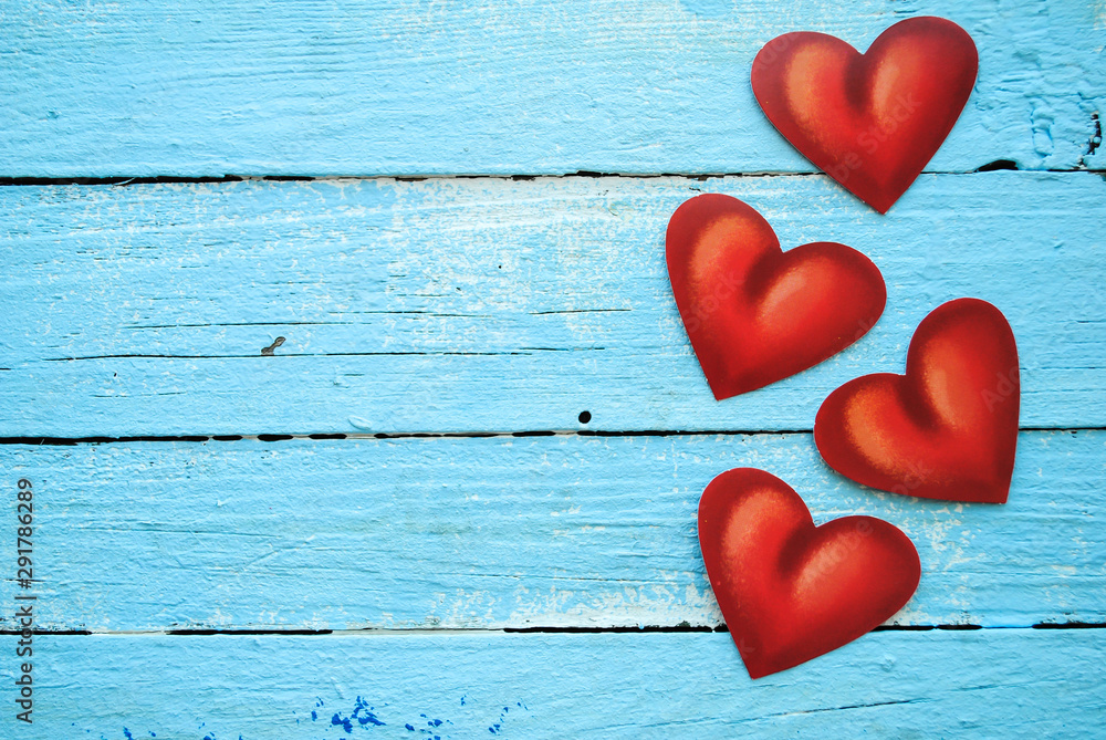 Red paper hearts on blue wooden background. Valentines day. Red paper hearts on blue wooden background. Valentines day.