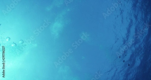 Low angle, ocean bubbles in slow motion