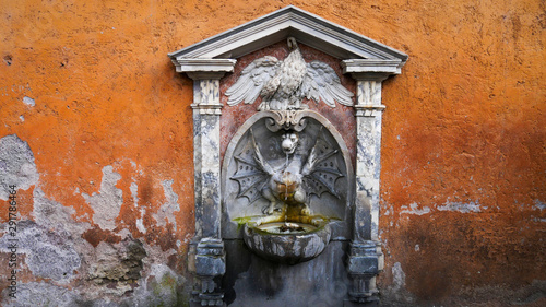 Small fountains of the city of Rome, Italy. Fountain of the dragon in the Vatican in the Way to Reconciliation