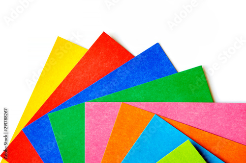 Top view of various colorful sheets of cardboard on a white background