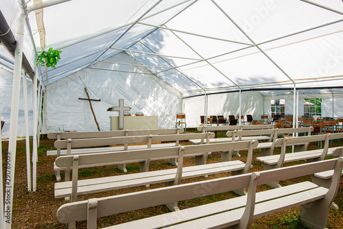 Photography Pulpit, cross and benches at a tent revival.