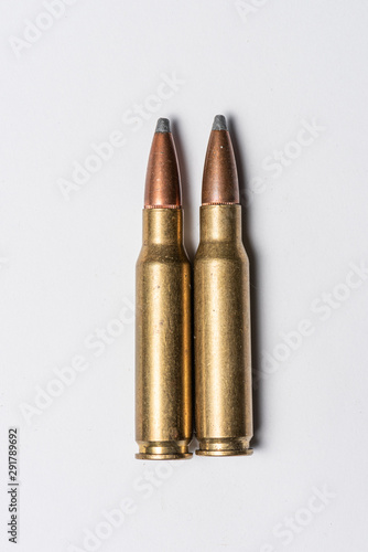 Old rifle bullets on white background.