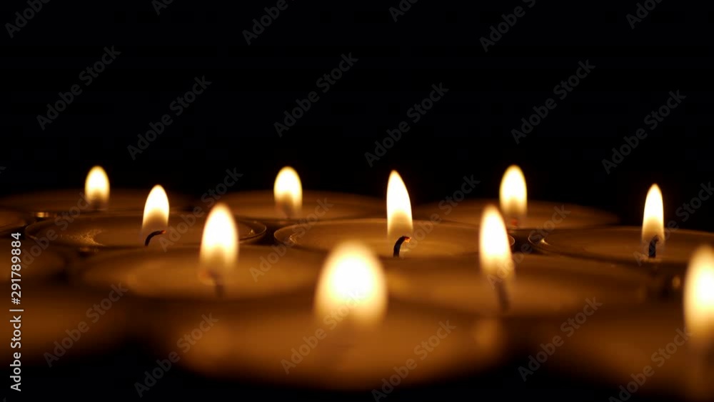 Burning candle on a black background. Religion symbol Burning candle on a black background. Religion symbol