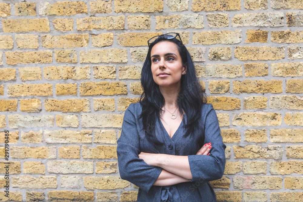 Portrait of a woman with brick wall background Portrait of a woman with brick wall background