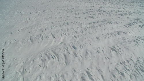 Helicopter flies over polar glacier, point of view